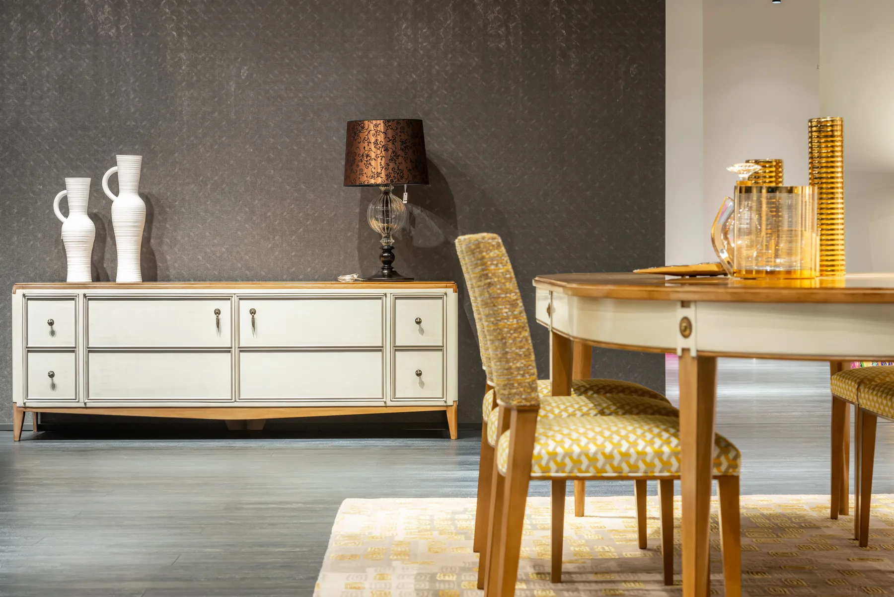 Dining room with a sideboard, table lamp and upholstered chairs