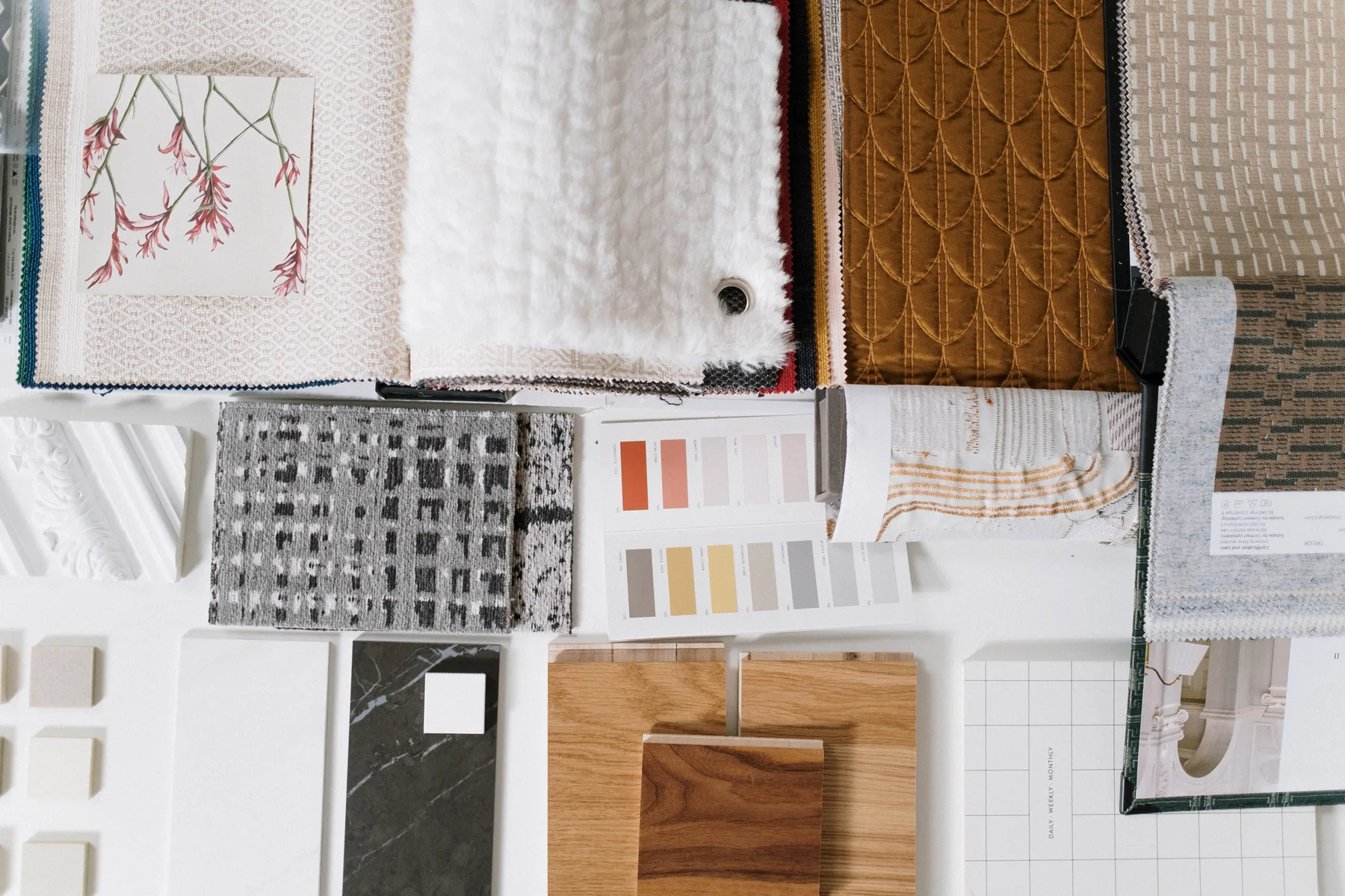 Fabric and textile samples with paint colour swatches laid up as a board