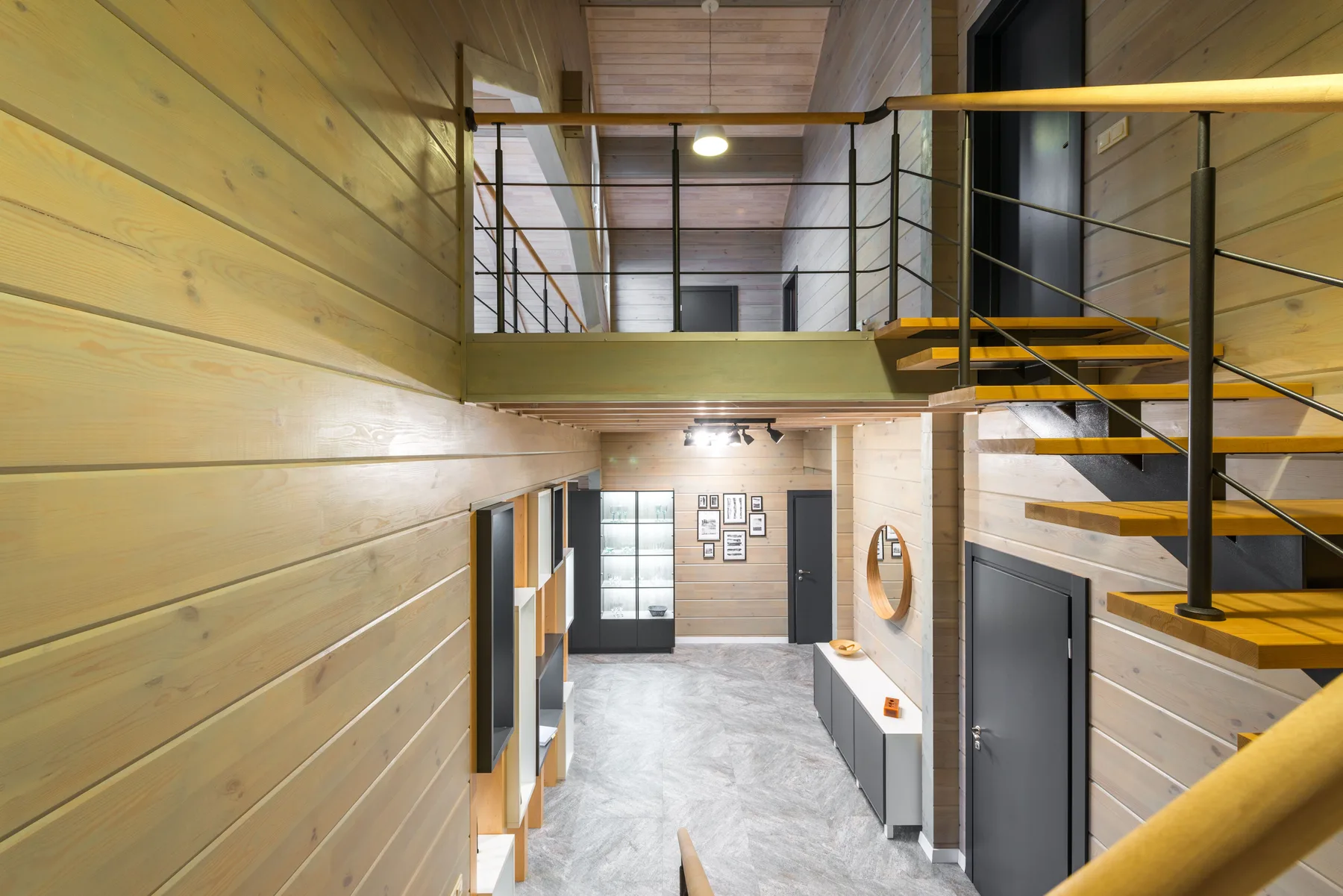 Hall and stair with olive panelling and a mirror by the front door